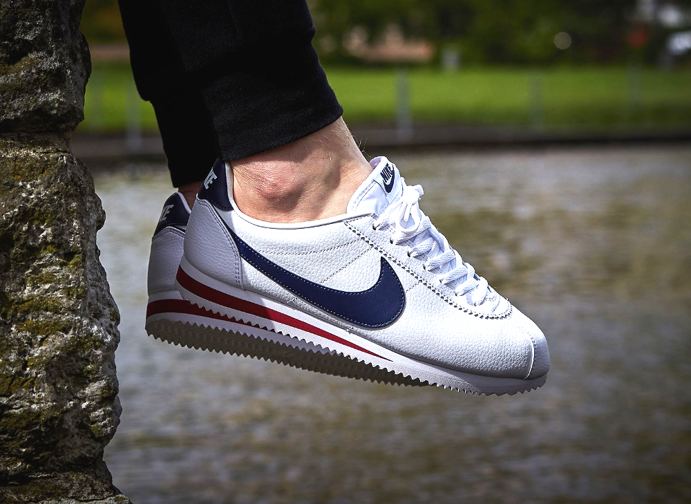 white nike cortez with navy blue swoosh